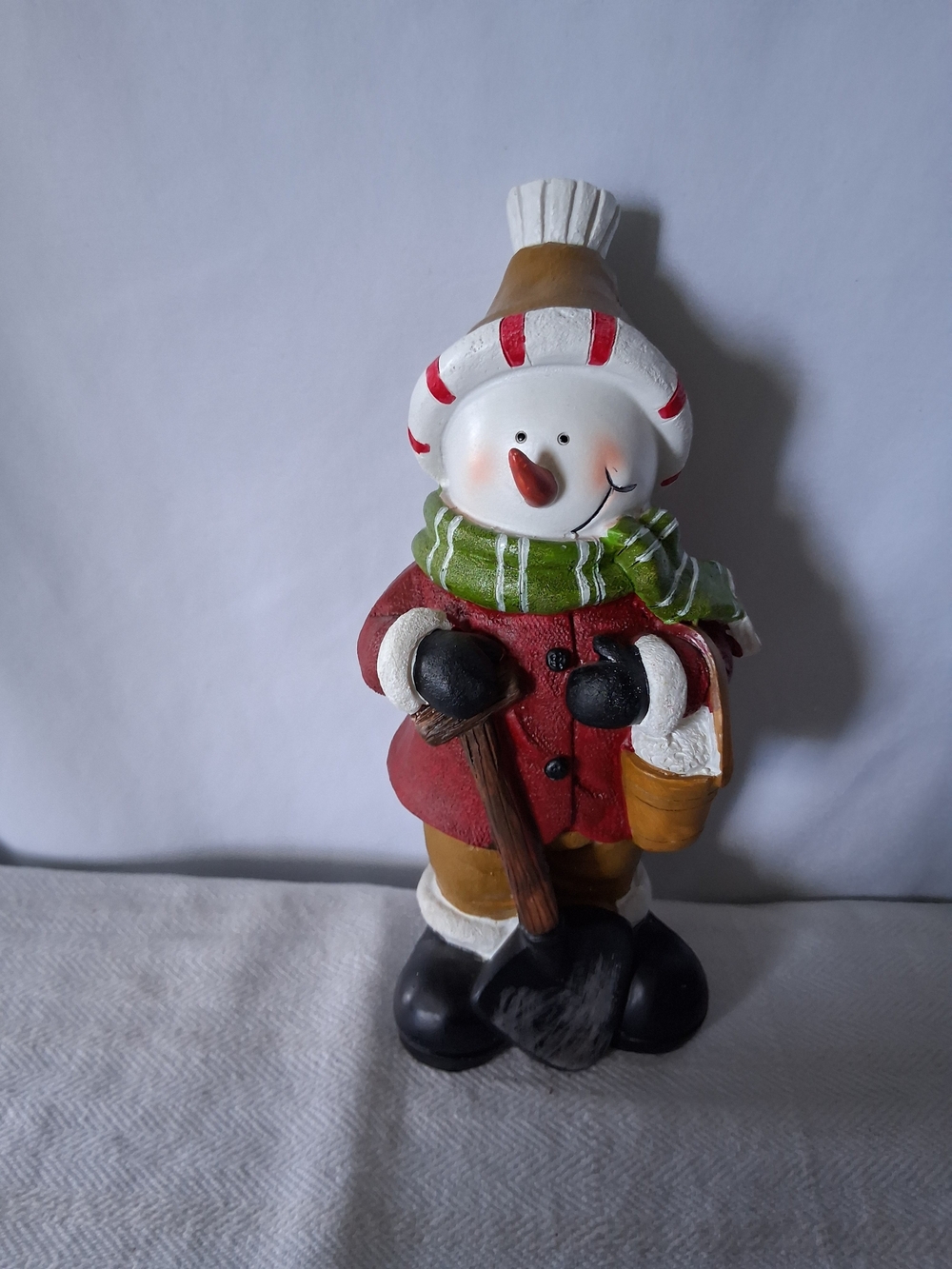Festive Snowman Figurine in Red Coat with Green Scarf